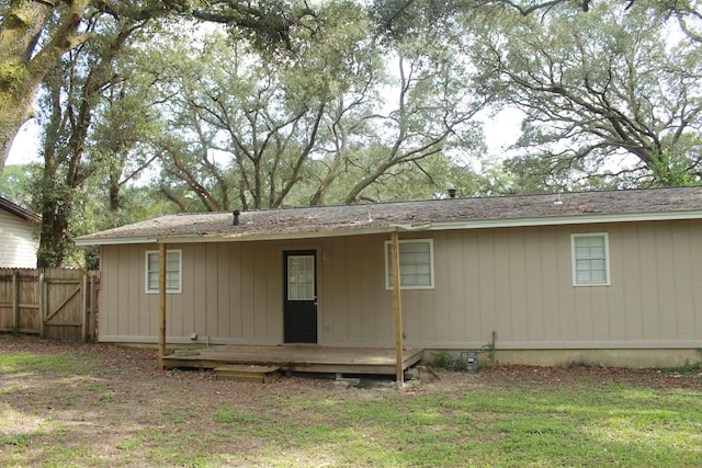 back of property featuring a yard