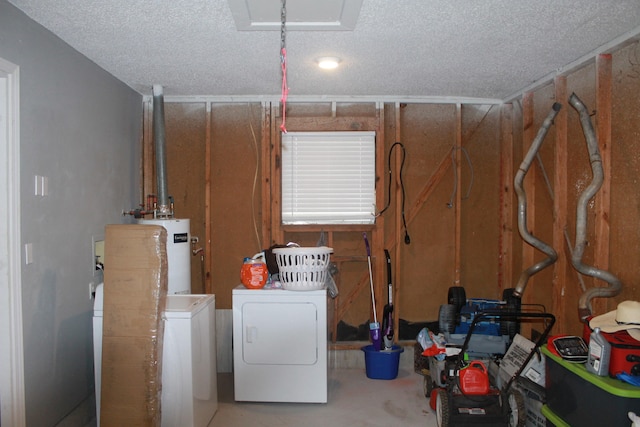 clothes washing area featuring separate washer and dryer, a textured ceiling, and water heater