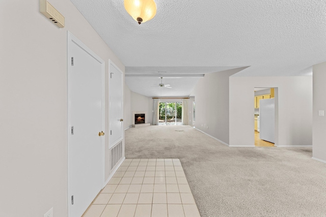 interior space with light carpet and a textured ceiling