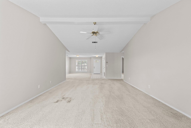 unfurnished living room featuring ceiling fan, light colored carpet, and lofted ceiling with beams