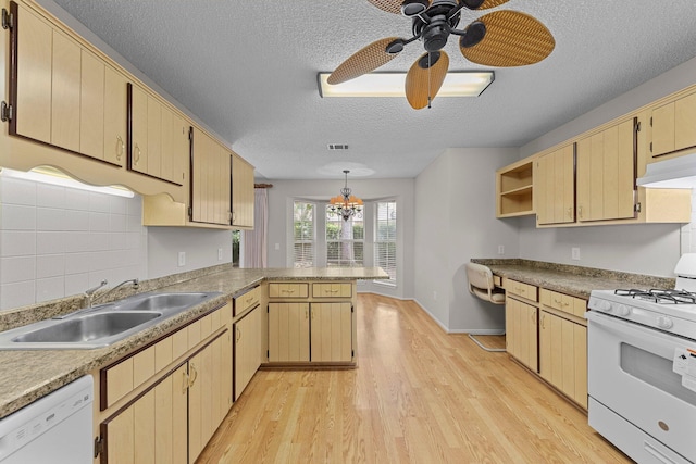 kitchen with light hardwood / wood-style flooring, white appliances, sink, kitchen peninsula, and ceiling fan