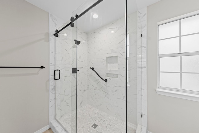 bathroom with a shower with door