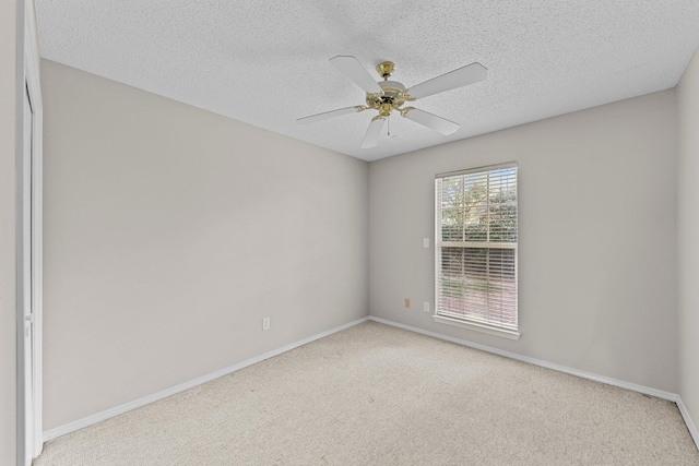 carpeted empty room with a textured ceiling and ceiling fan