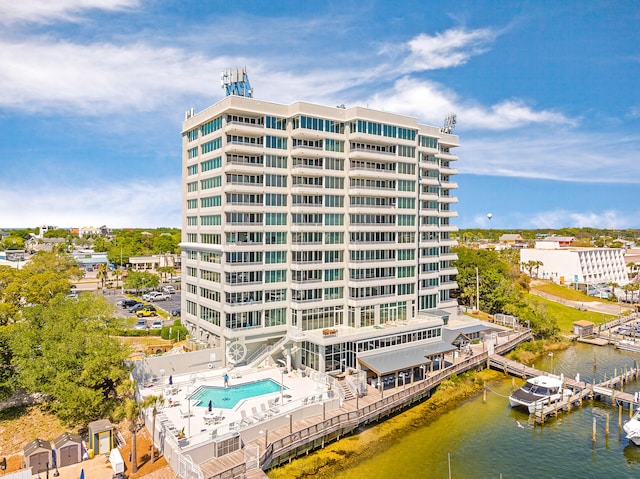 view of property with a water view and a community pool