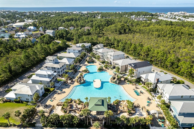 bird's eye view featuring a residential view, a water view, and a forest view