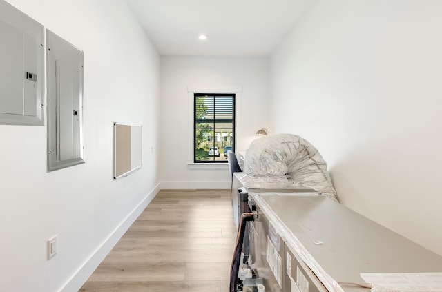 interior space featuring light wood-style flooring, electric panel, baseboards, and recessed lighting