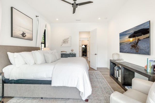 bedroom featuring ceiling fan, baseboards, wood finished floors, and recessed lighting