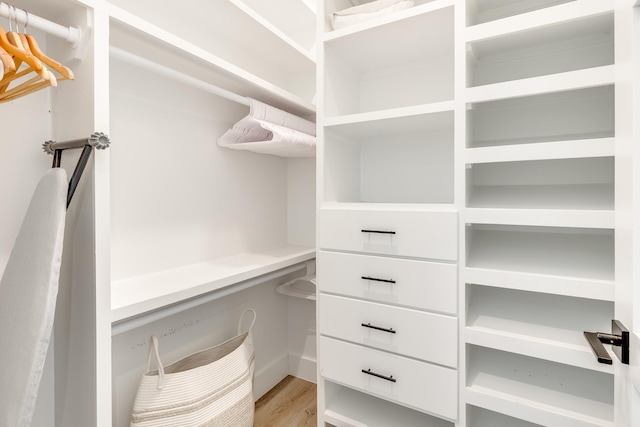 walk in closet with light wood-type flooring