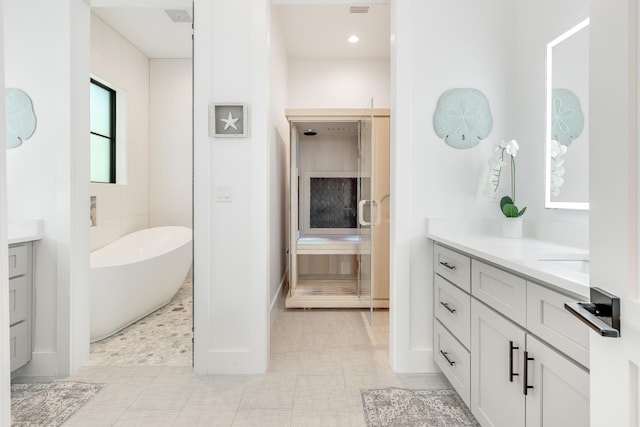 full bathroom featuring a freestanding bath and vanity