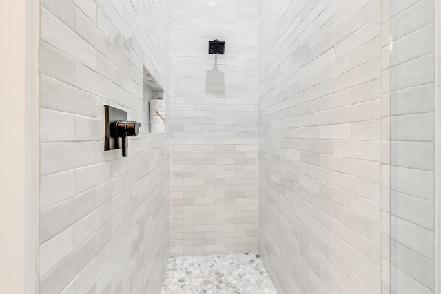 bathroom with a tile shower