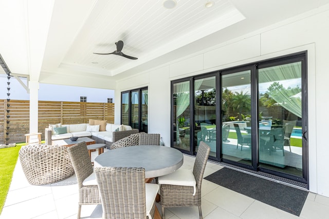 view of patio with a ceiling fan, fence, and an outdoor living space