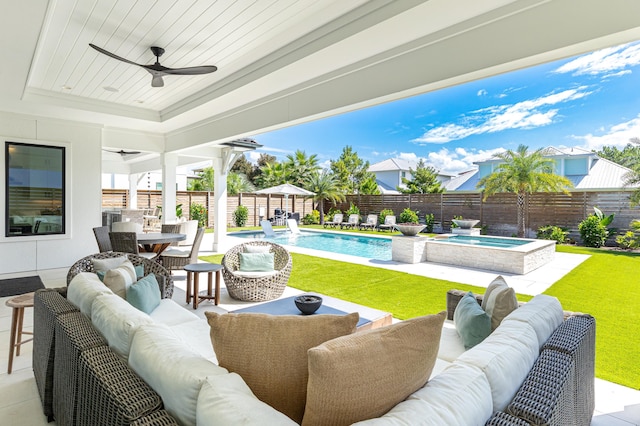 view of patio / terrace with ceiling fan, a fenced backyard, an outdoor hangout area, and a fenced in pool