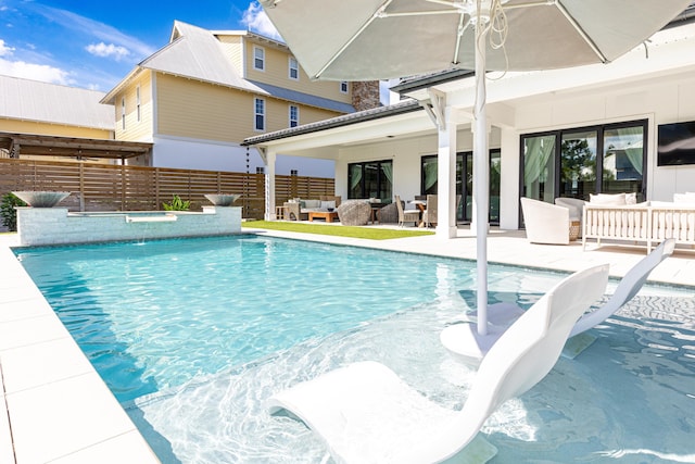 view of pool with fence, an outdoor living space, a fenced in pool, and a patio