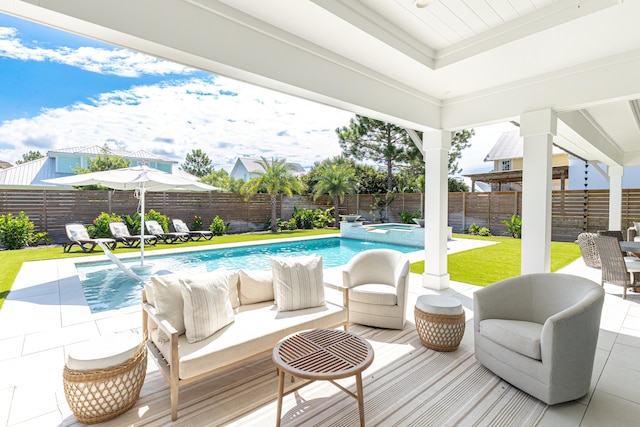 exterior space with a patio, a pool with connected hot tub, a fenced backyard, and an outdoor living space