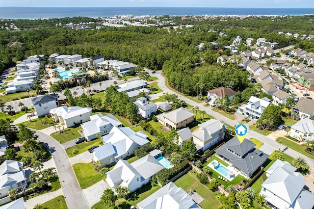 drone / aerial view with a residential view and a view of trees