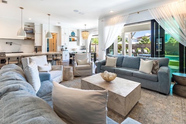 living area featuring visible vents and recessed lighting