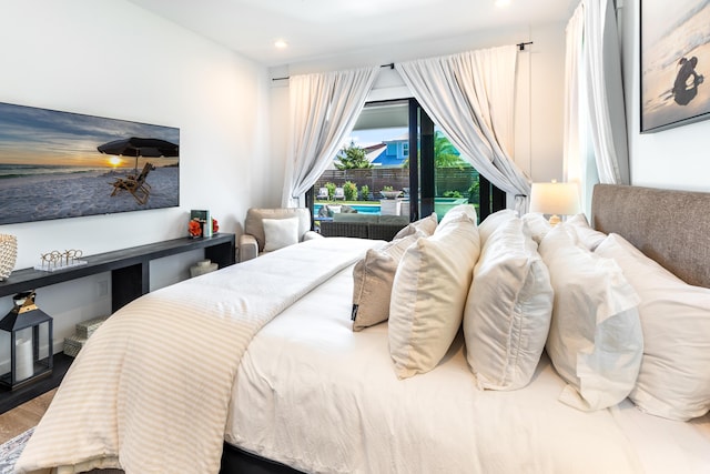 bedroom featuring access to outside, wood finished floors, and recessed lighting