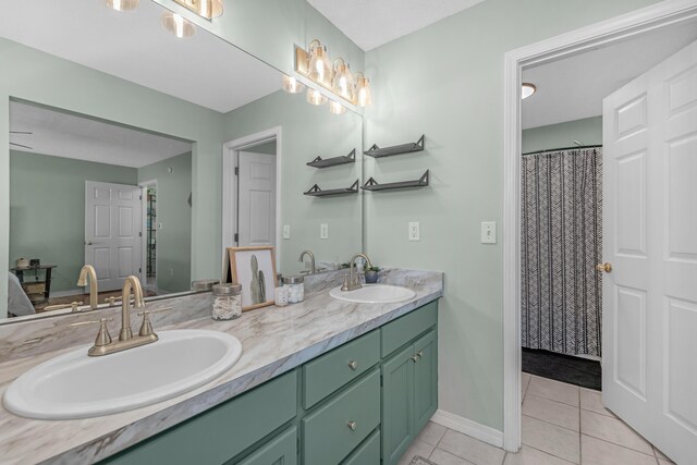 bathroom with curtained shower, tile patterned flooring, and vanity