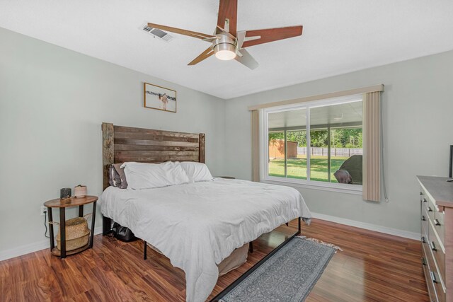 bedroom with dark wood-type flooring and ceiling fan