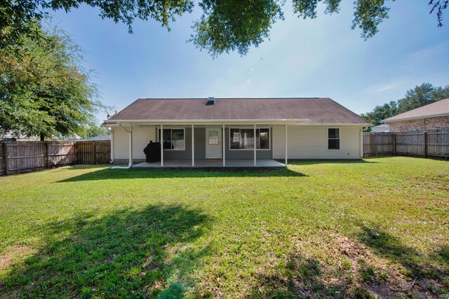 back of house featuring a patio area and a yard