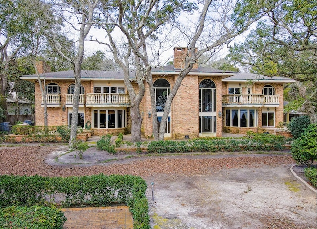 rear view of property featuring a balcony