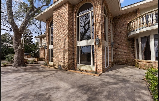 view of home's exterior with a patio area and a balcony