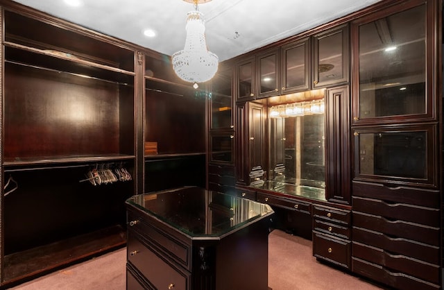 spacious closet featuring light colored carpet