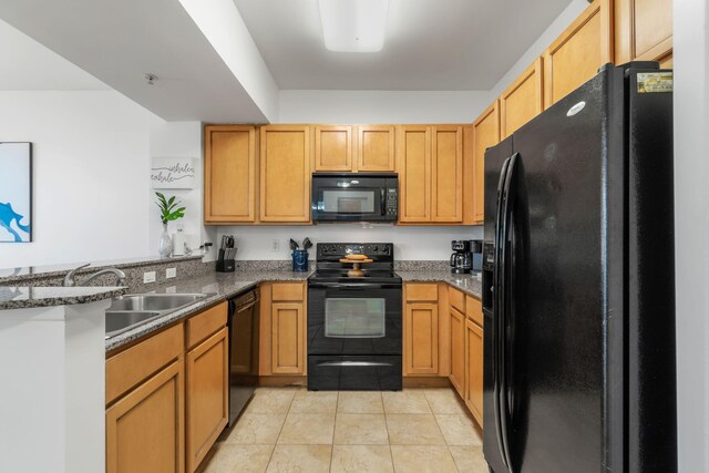 kitchen with light tile patterned floors, stone countertops, sink, black appliances, and kitchen peninsula