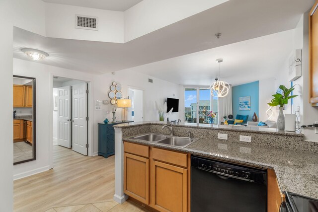 kitchen featuring light stone countertops, dishwasher, light hardwood / wood-style floors, sink, and a chandelier