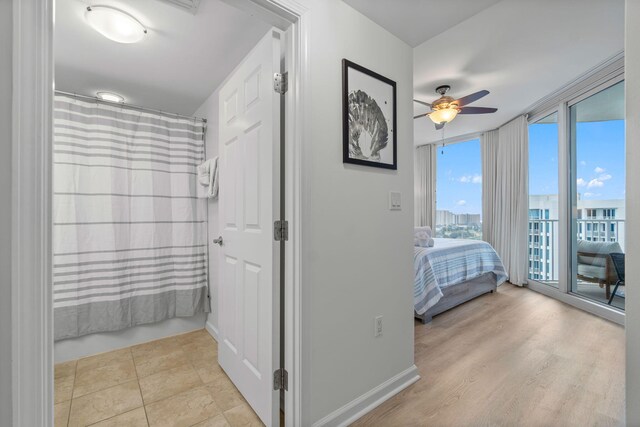 tiled bedroom featuring access to outside and ceiling fan