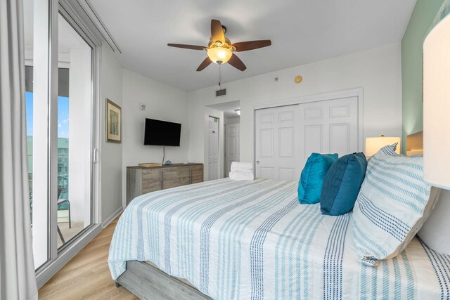 bedroom featuring a closet, access to exterior, ceiling fan, and light hardwood / wood-style floors