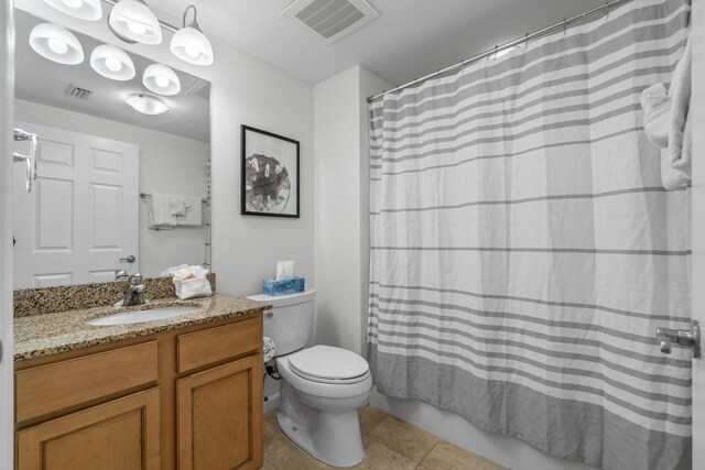 full bathroom featuring vanity, toilet, tile patterned floors, and shower / bath combo