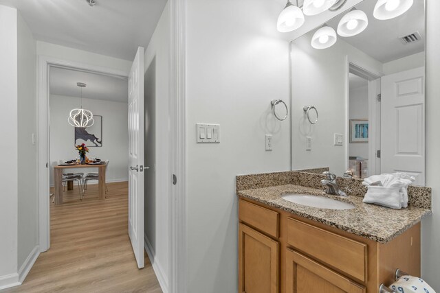 bathroom with vanity and wood-type flooring