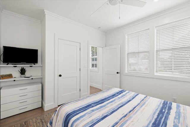 bedroom featuring crown molding, ceiling fan, and hardwood / wood-style floors