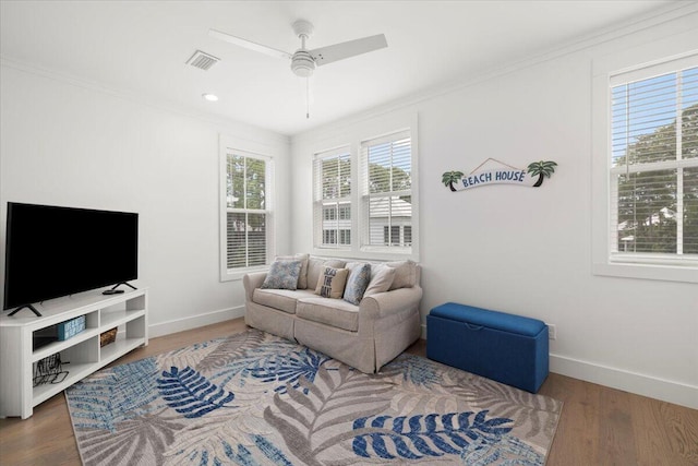 living room with crown molding, hardwood / wood-style floors, and ceiling fan