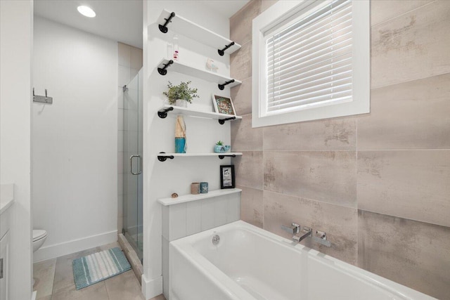 bathroom with shower with separate bathtub, toilet, and tile patterned floors