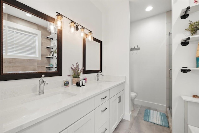 bathroom featuring tile patterned flooring, vanity, a shower with shower door, and toilet