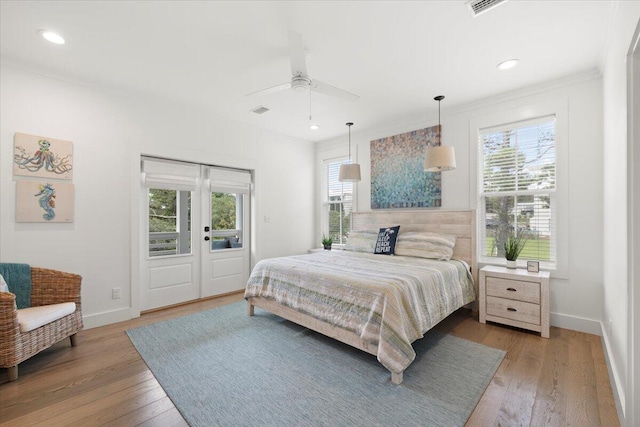 bedroom with ceiling fan, light wood-type flooring, and multiple windows