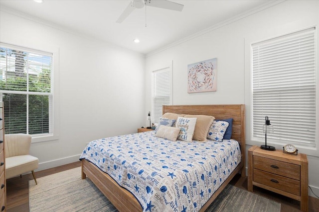 bedroom featuring ceiling fan, ornamental molding, and wood-type flooring