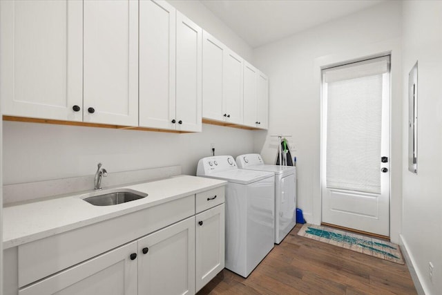 washroom with dark hardwood / wood-style flooring, cabinets, independent washer and dryer, and sink