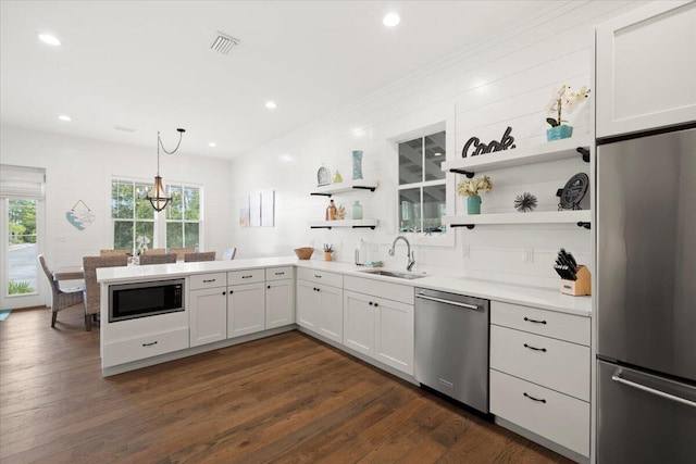 kitchen featuring plenty of natural light, sink, appliances with stainless steel finishes, and white cabinetry