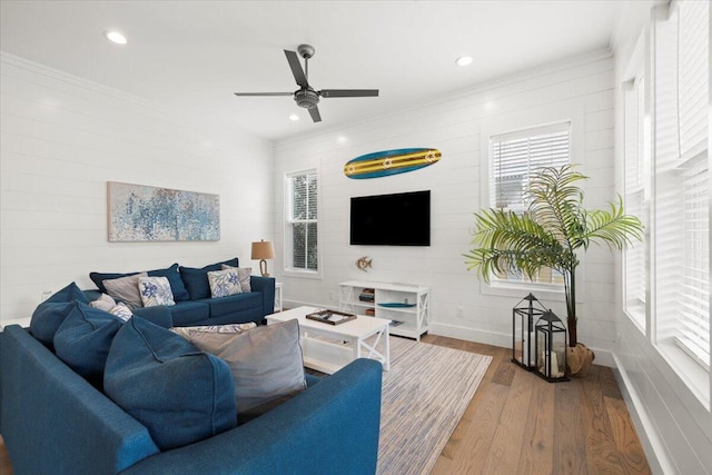 living room featuring ceiling fan and hardwood / wood-style flooring