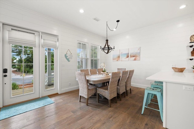 dining area with a chandelier and dark hardwood / wood-style flooring