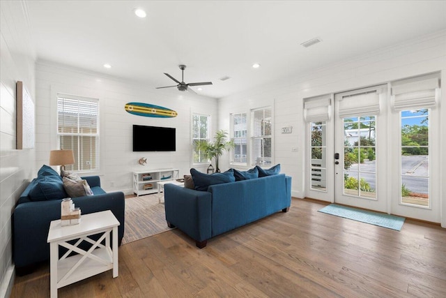 living room with ceiling fan and hardwood / wood-style flooring