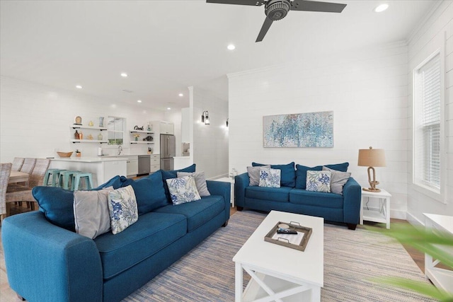 living room featuring a wealth of natural light and ceiling fan