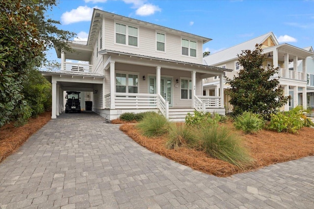 view of front of home with covered porch and a carport