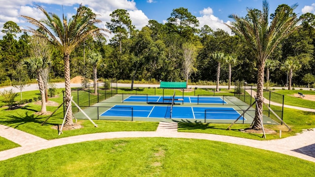 view of tennis court with a yard