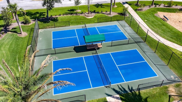 view of basketball court featuring a tennis court and fence