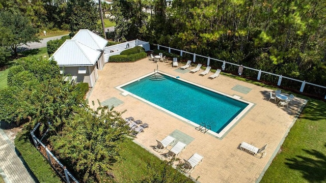 pool with a patio and fence