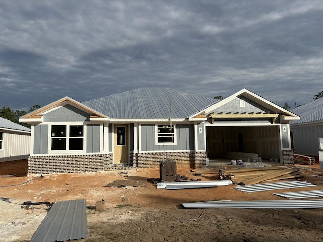 view of front of home with brick siding and an attached garage